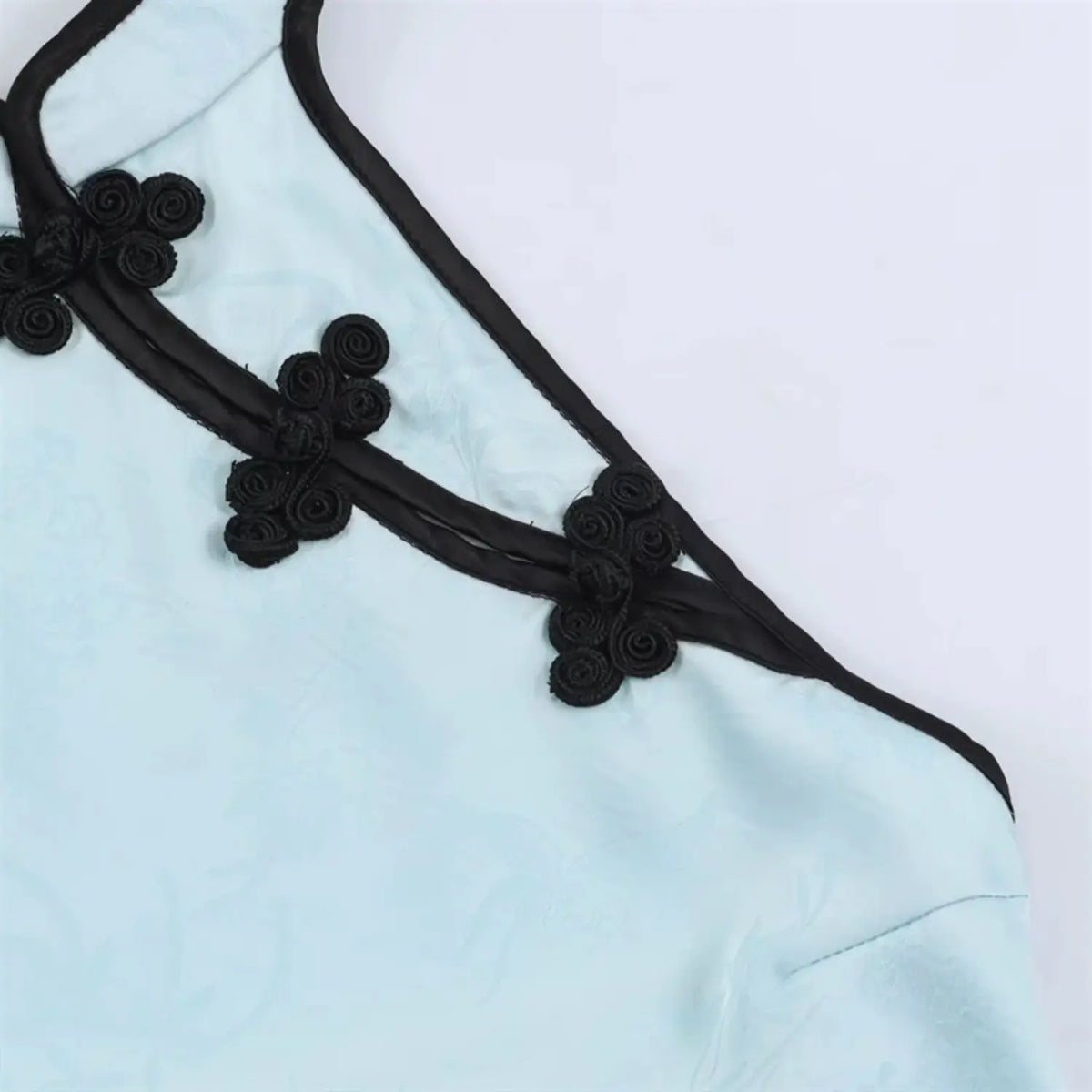 Macro close‑up of black traditional frog button ornament
