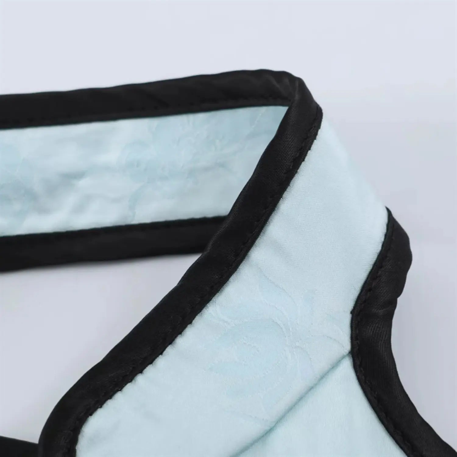 Close‑up of halter neck black piping trim
