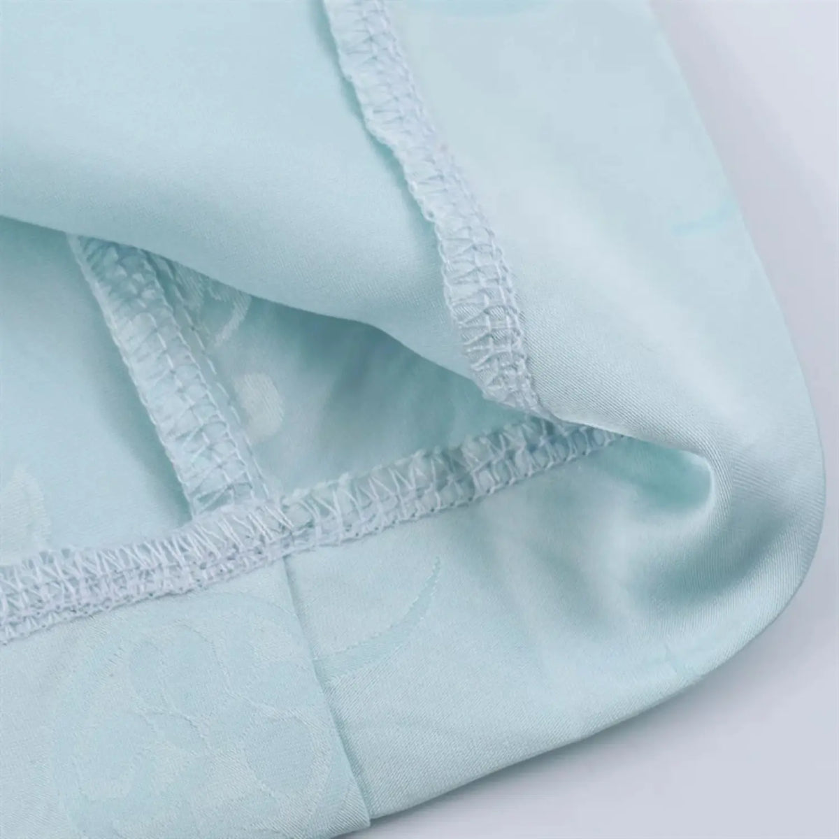 Partial close‑up of dress inner lining and hem stitching