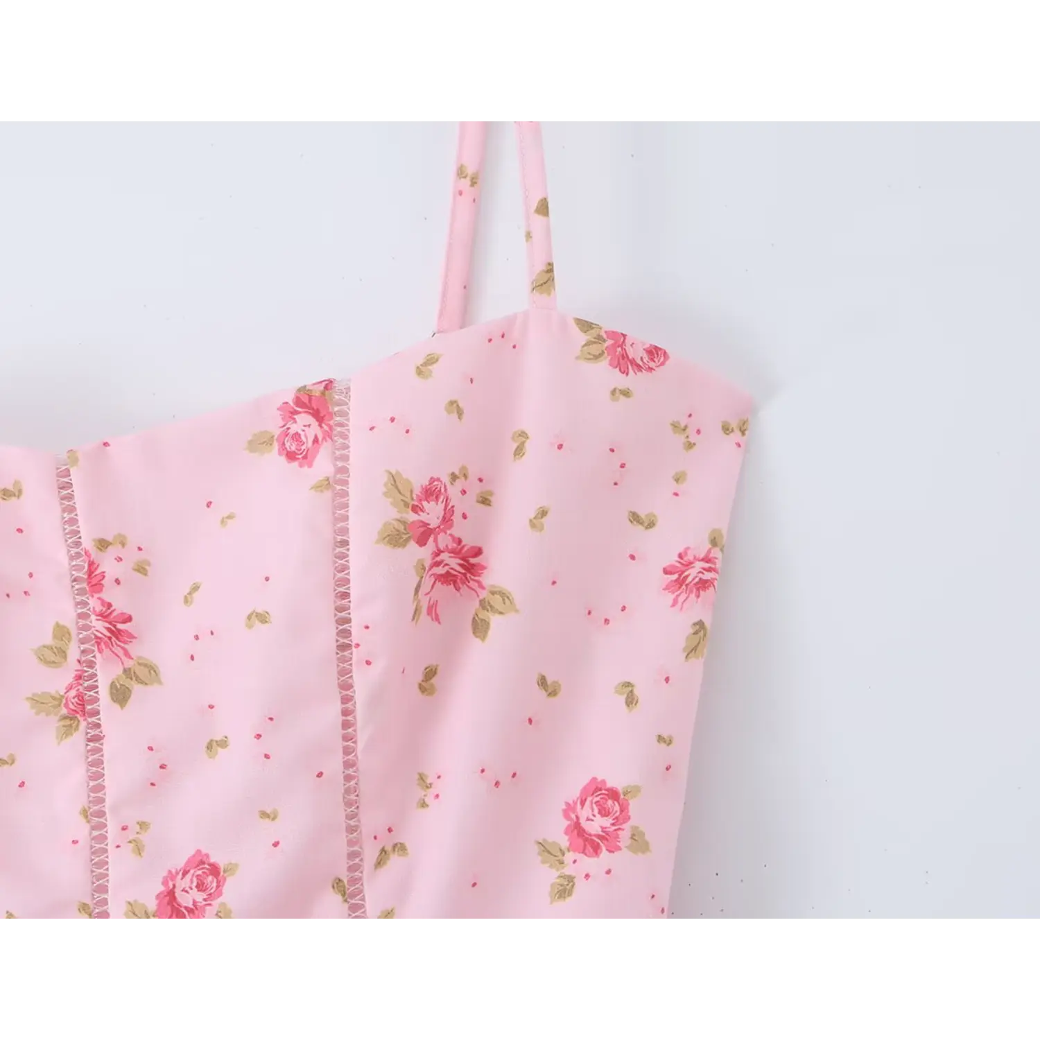 Close‑up of spaghetti strap and bodice detail of light pink floral maxi dress