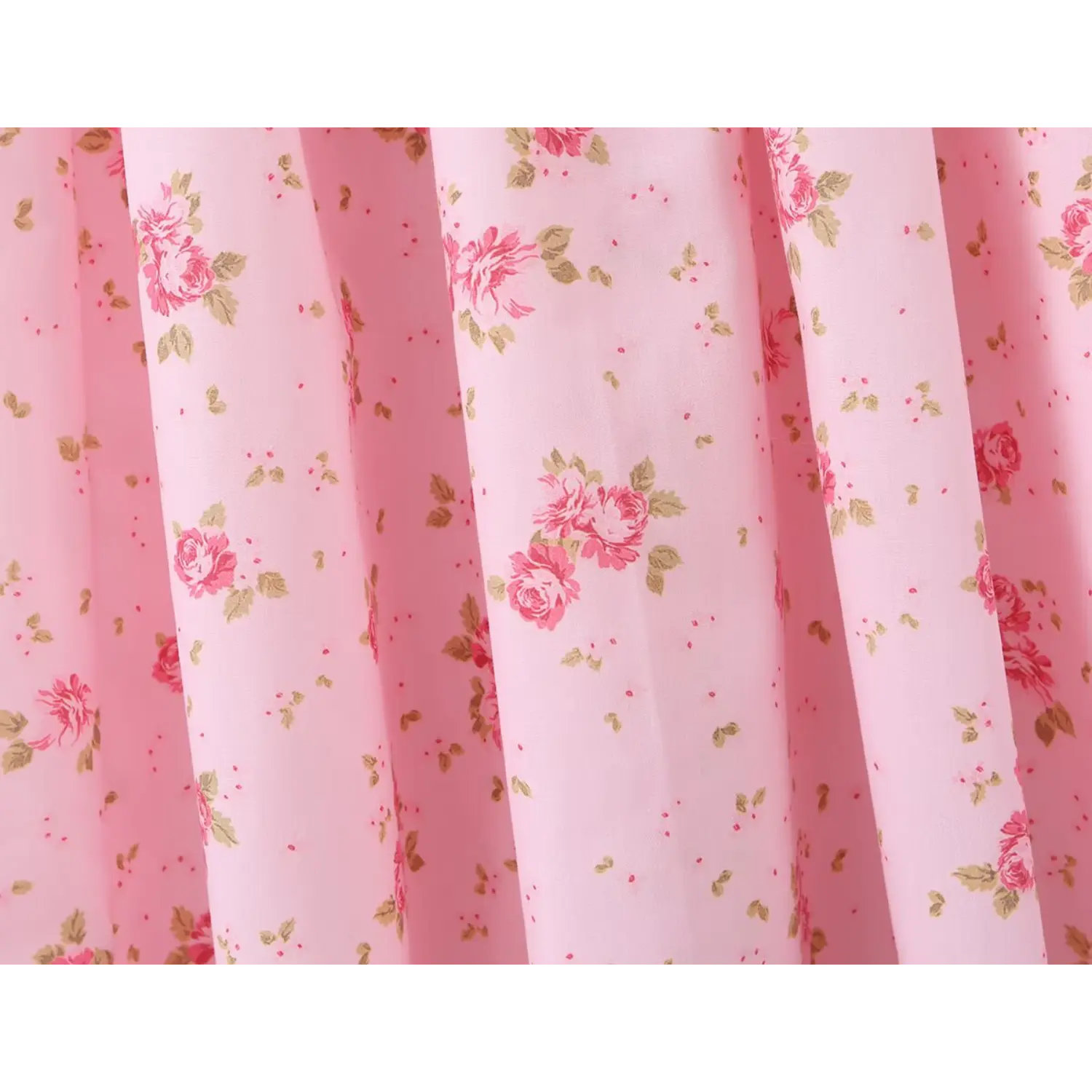 Close‑up of floral print fabric on skirt of light pink cami maxi dress