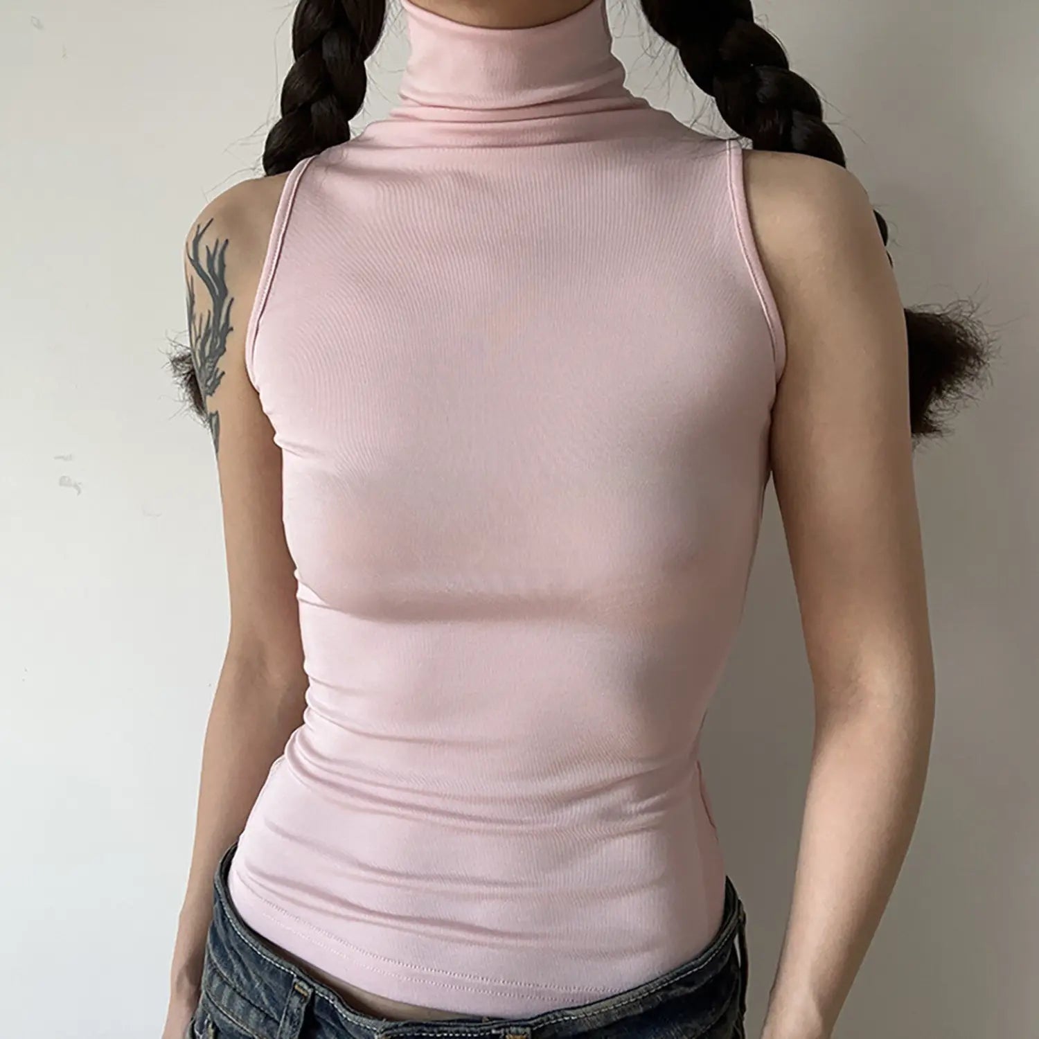 Front torso model view, light pink sleeveless turtleneck tank top, stretch knit material