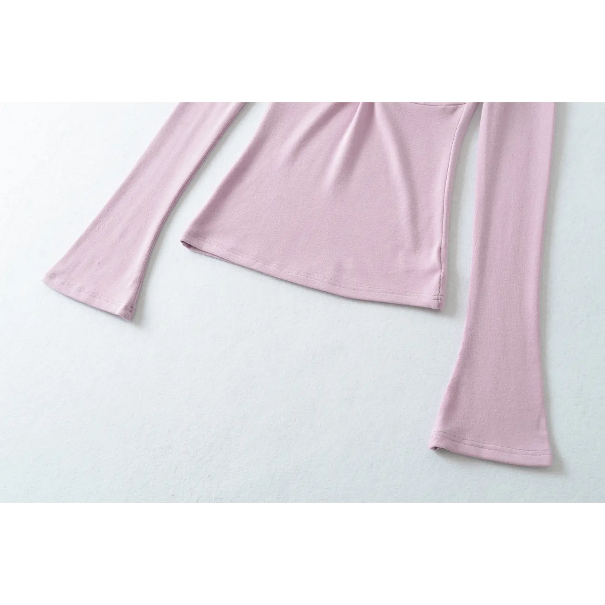 Detail shot of lilac top flare sleeve and bottom hem, slim fitted hem, flared cuff design