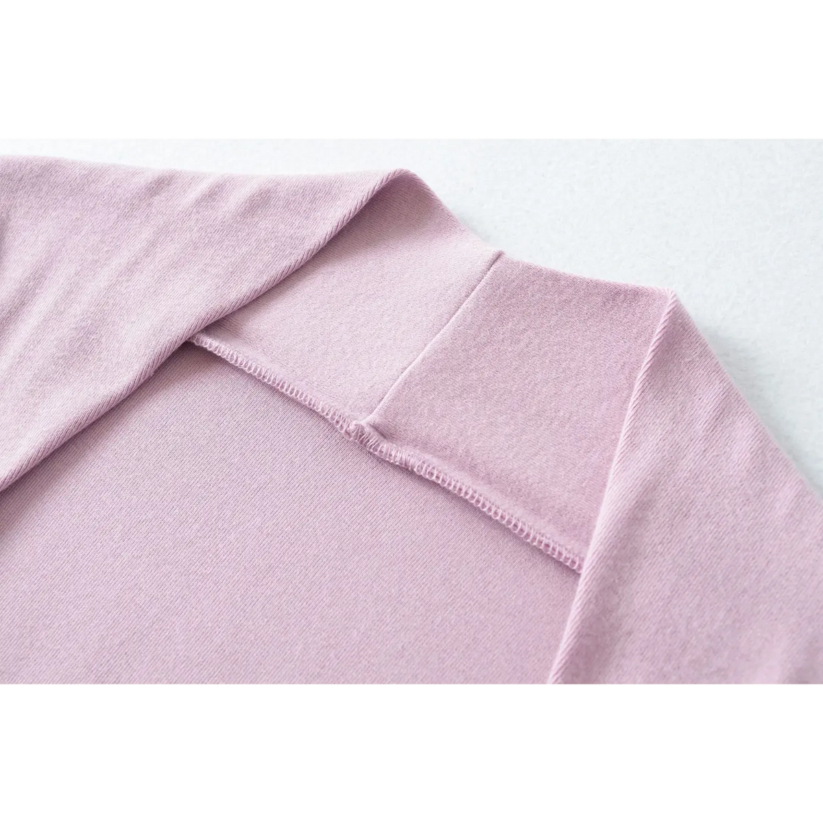 Close up of lilac top halter neck, fine stitching and seam details on stretch knit material
