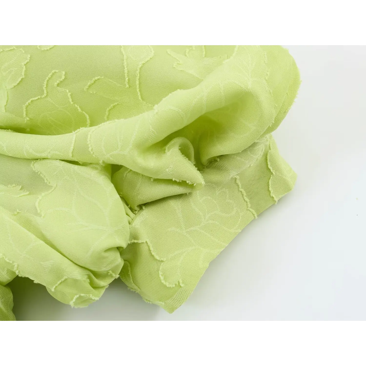 Crumpled fabric close-up showcasing the embossed burnout floral texture, lightweight soft sheer material
