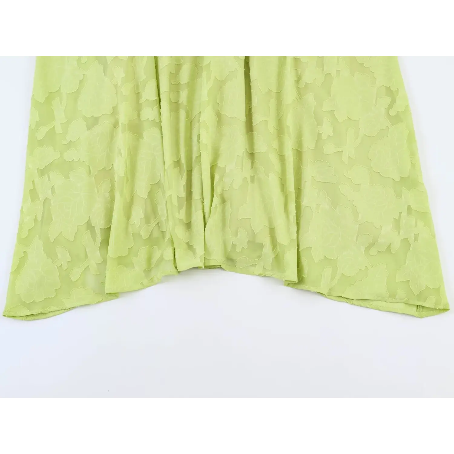 Close-up of full skirt hem, showing sheer burnout floral jacquard, soft layered drape and neat finished hem stitching