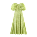 Full back flat shot of lime green burnout floral maxi dress, gathered bubble short sleeves, central vertical back seam with invisible zipper, fitted waist with darts and flowing A-line floor-length skirt, all-over embossed sheer floral jacquard fabric