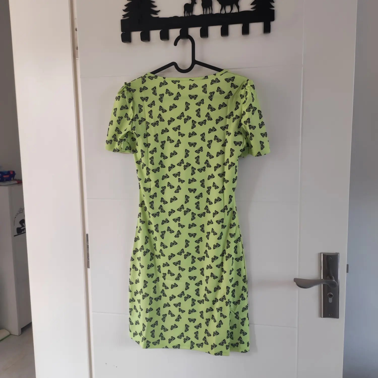 Hanging back full view lime green square neck short sleeve bodycon dress with black butterfly all‑over print