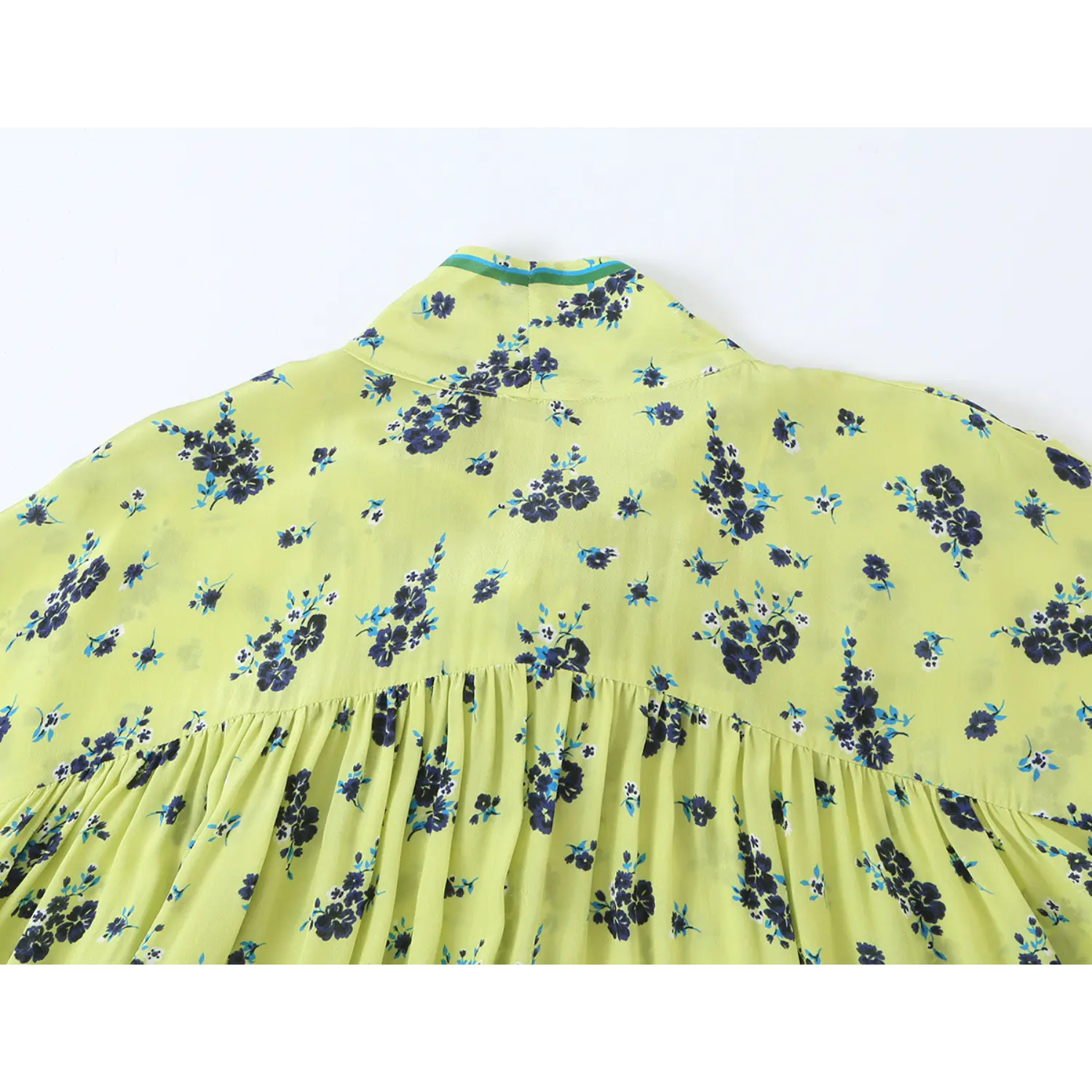 Close‑up back neck yoke and top gathering pleats of lime green ditsy floral long sleeve blouse