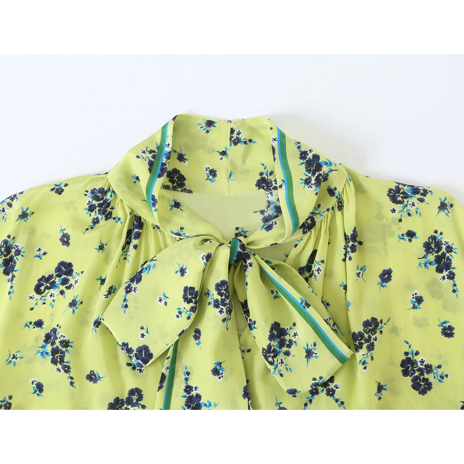 Close‑up shot of self tie bow neck collar on lime green navy floral print long sleeve blouse