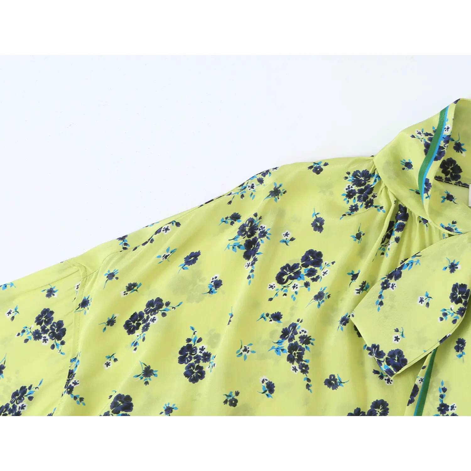 Close‑up shoulder and fabric print texture of lime green ditsy floral women blouse