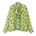 Flat lay front view lime green long sleeve blouse with navy blue floral print and neck tie bow detail