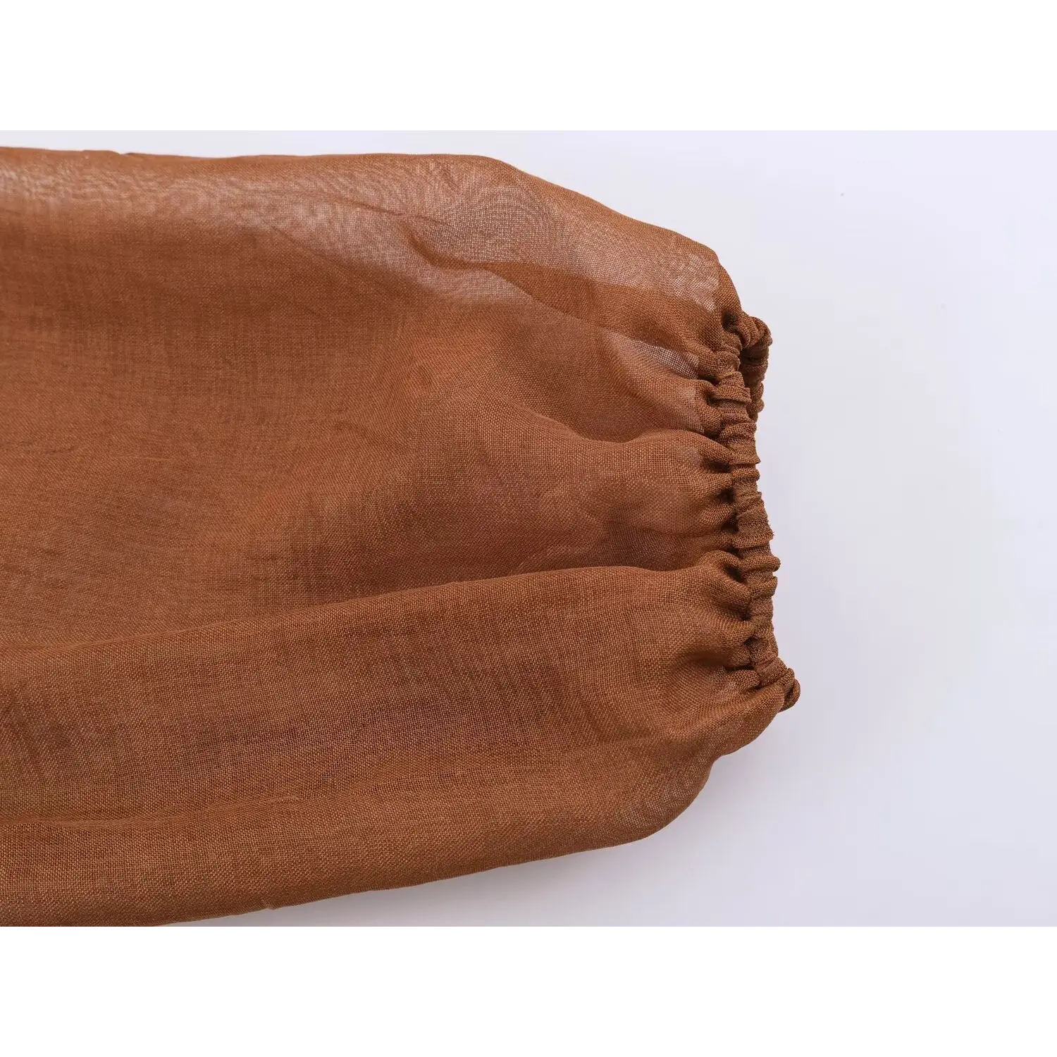Long puff sleeve hem close-up, elastic gathered bubble cuff, wrinkled sheer woven fabric