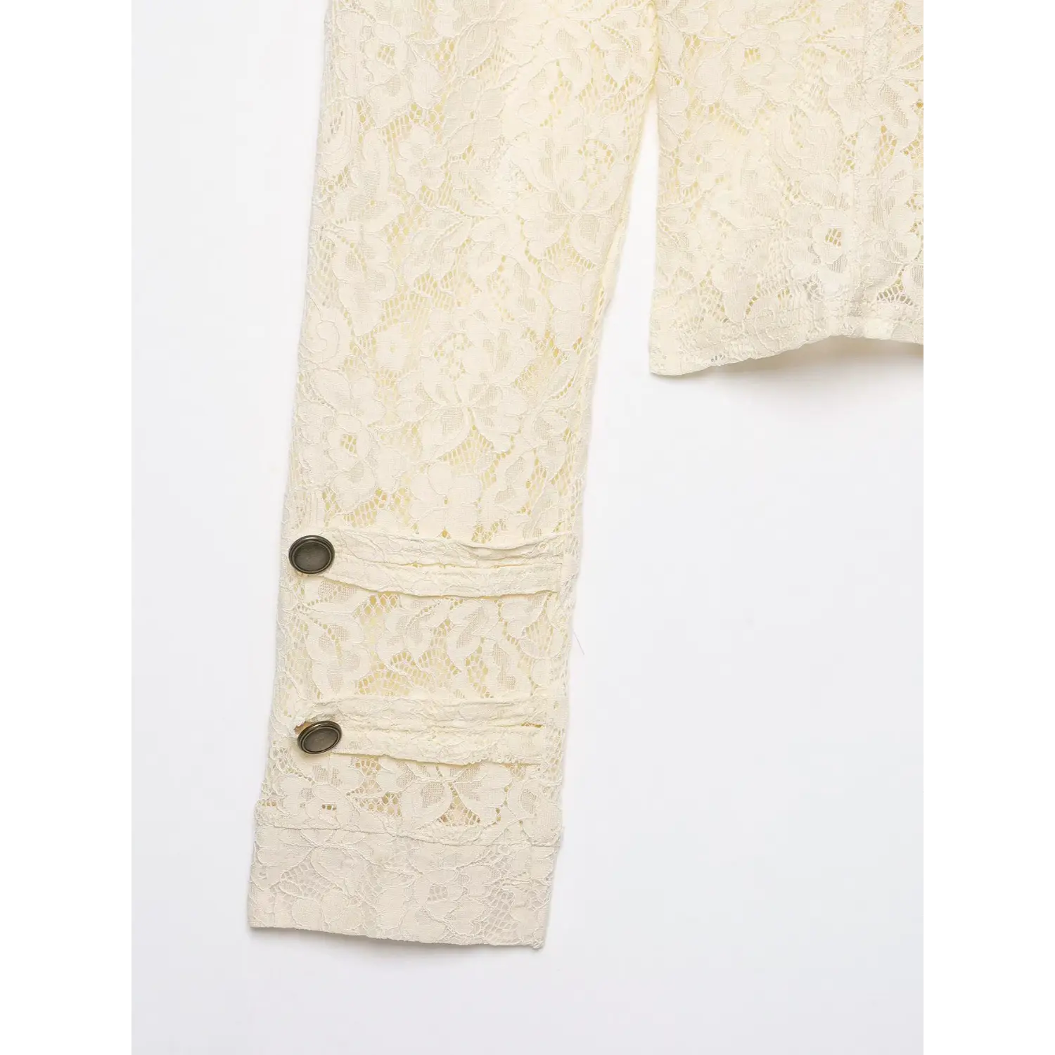 Detail shot of lace jacket cuff with double antique metal buttons, floral hollow lace material