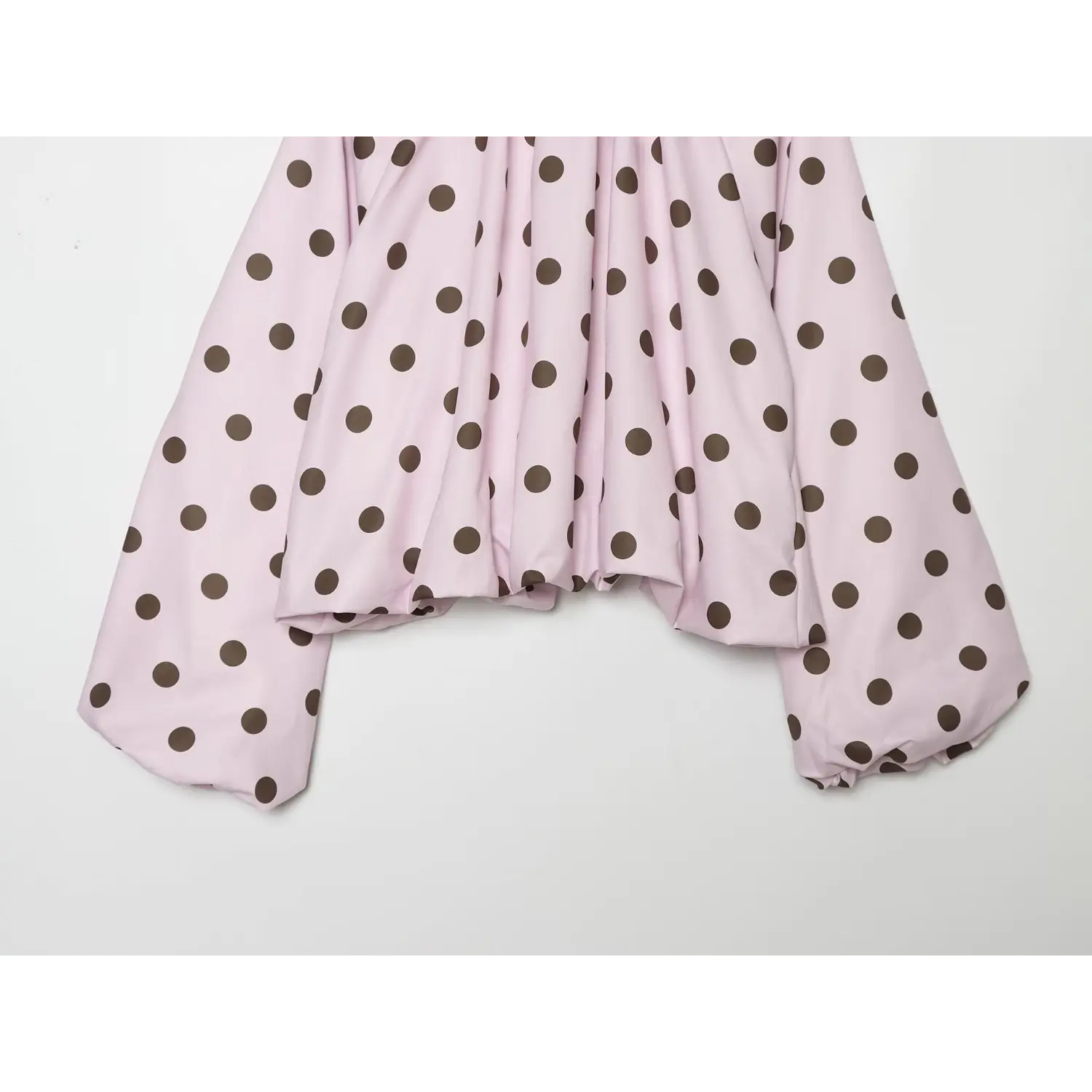 Lower torso flat partial shot, loose draped front, straight cropped hem, balloon long sleeve