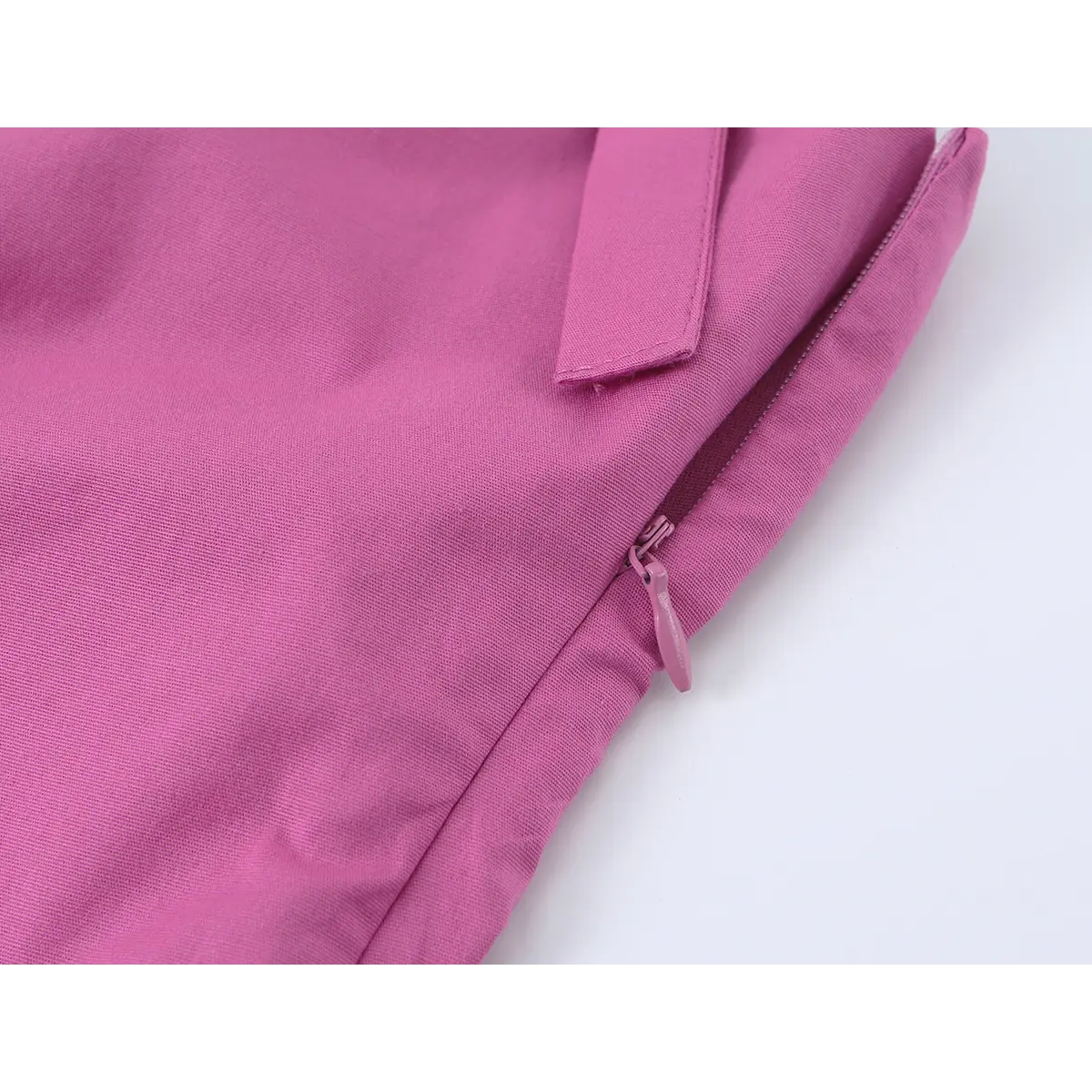 Close-up of the side metal zipper on the magenta halter dress