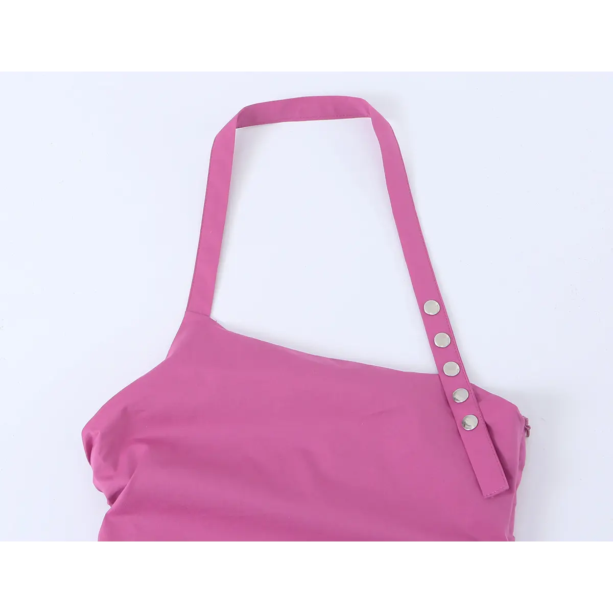Close-up of the halter strap and decorative buttons on the magenta mini dress