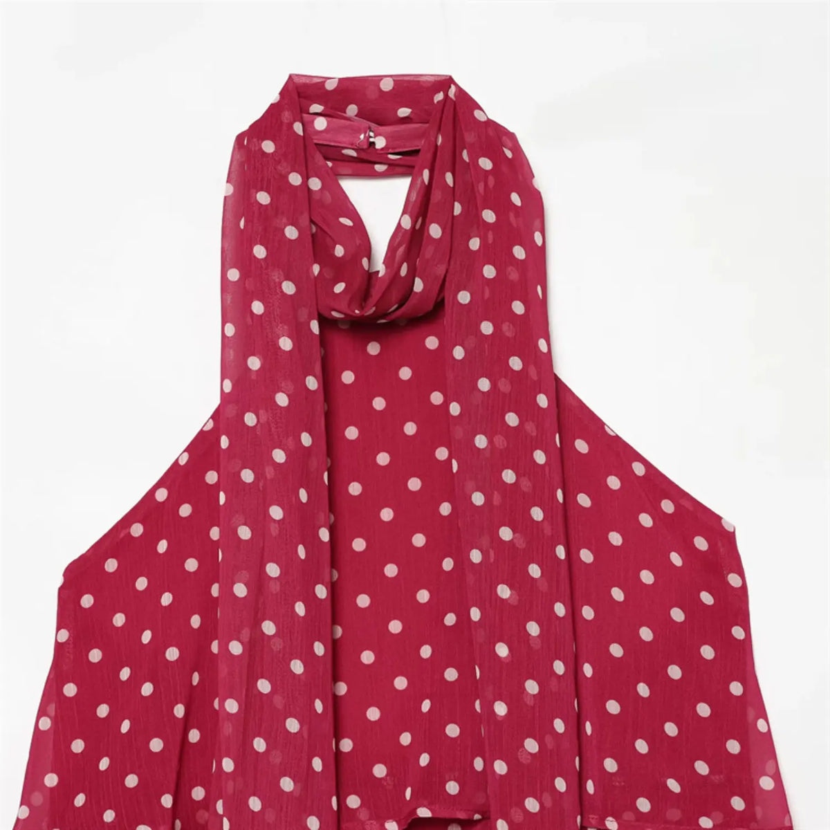 Flat‑lay magenta halter neck top with white polka dots crinkled chiffon fabric back clasp detail