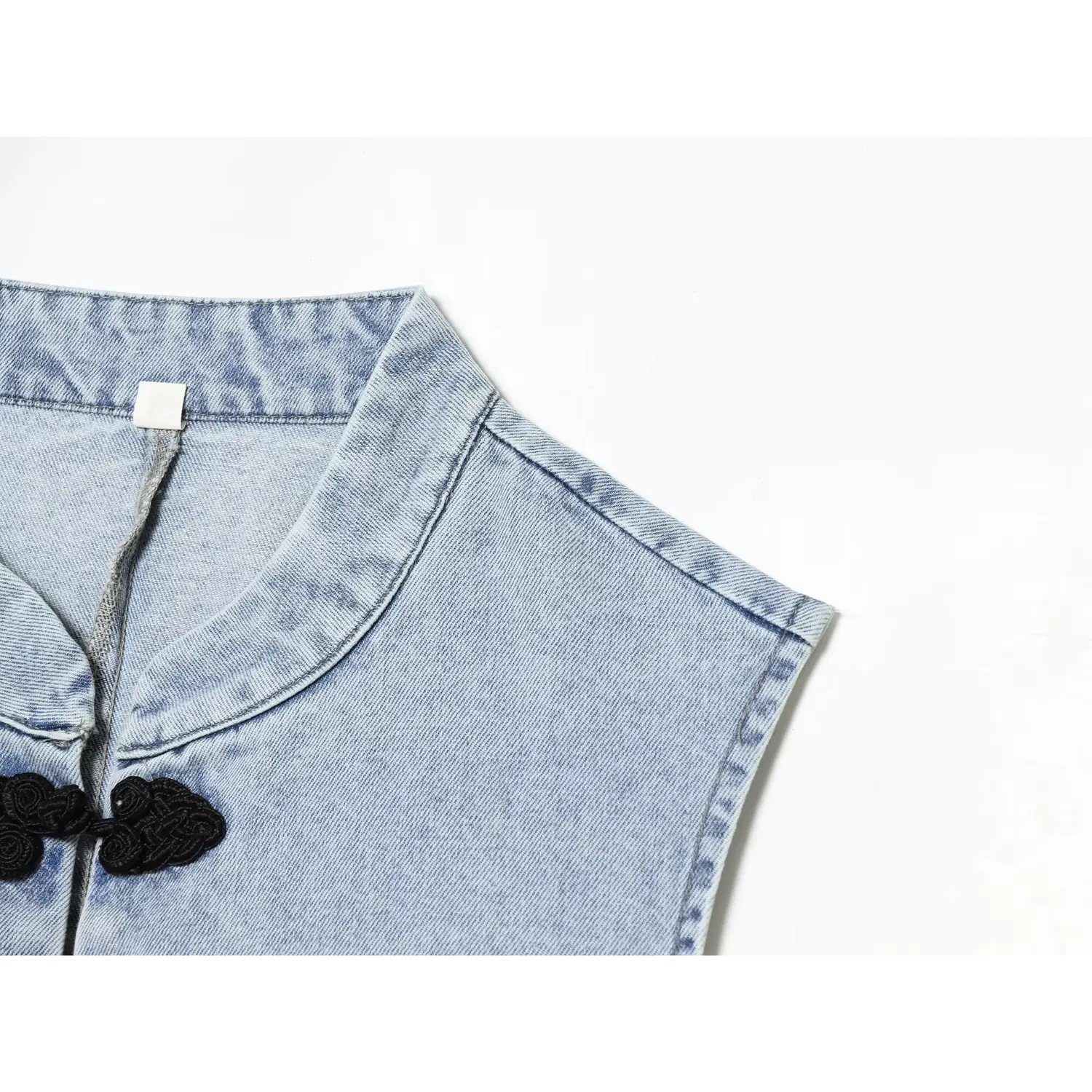 Detail view neat stitching on stand collar and sleeveless armhole binding
