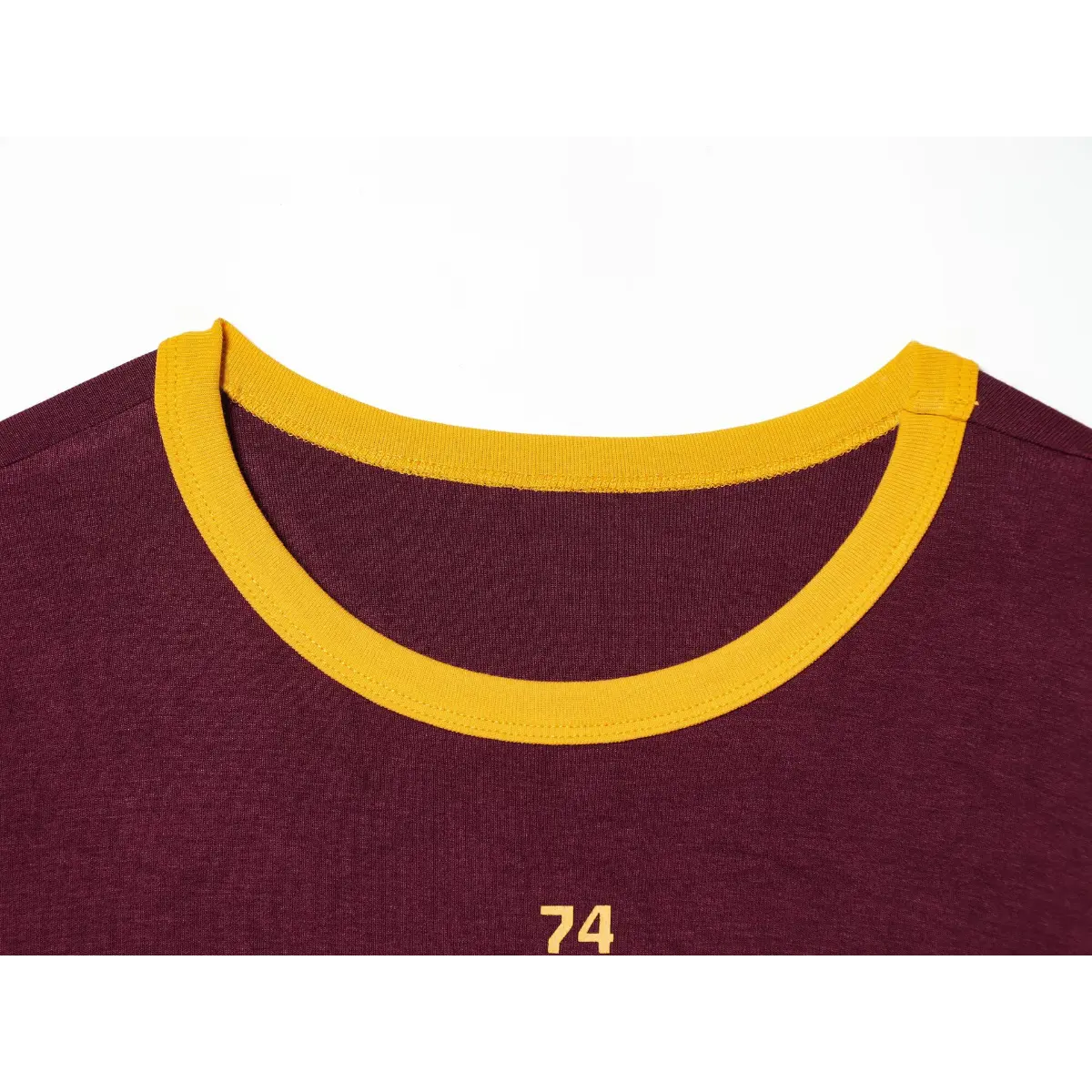 Front neck view of maroon ringer t-shirt, showing the yellow ribbed crew neck and partial front print
