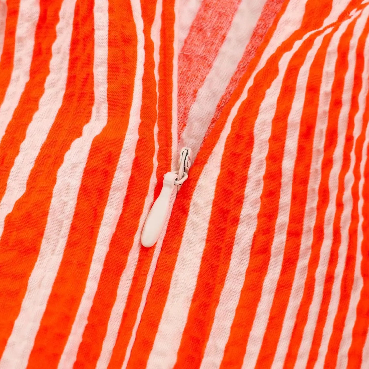 Closeup white invisible zipper at center back seam