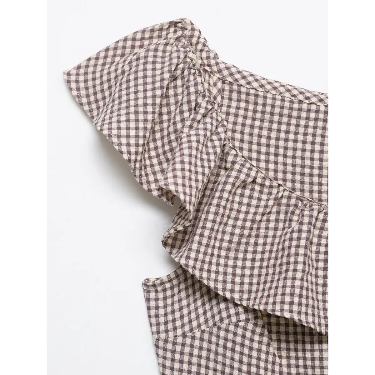 Shoulder detail of the mauve gingham dress, showing the ruffled off-the-shoulder design and elasticated edge