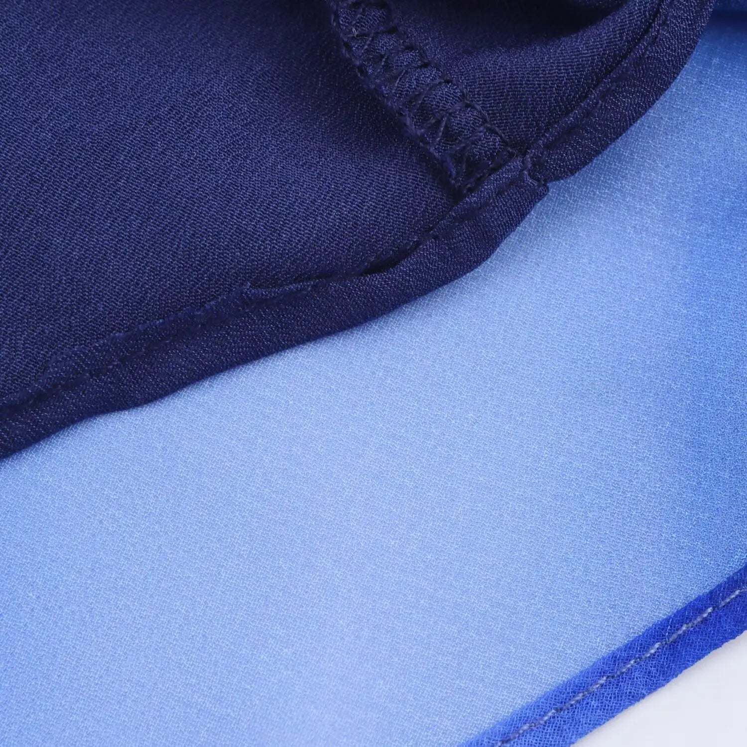 Close‑up of dress hem finished stitching, double‑layer chiffon lining, neat overlock seam workmanship
