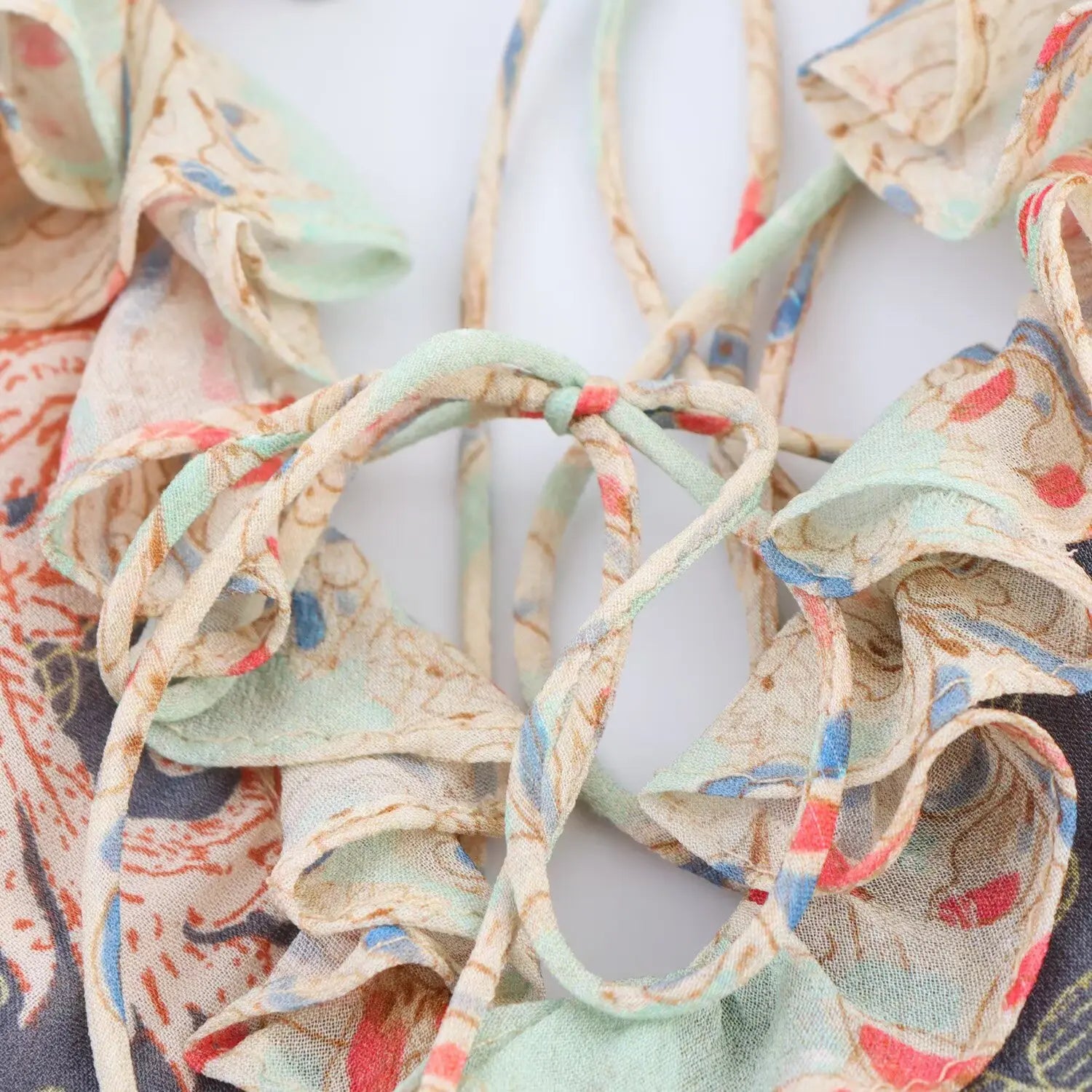 Close‑up of crisscross lace‑up back ties, printed fabric cords, adjustable tie‑back construction
