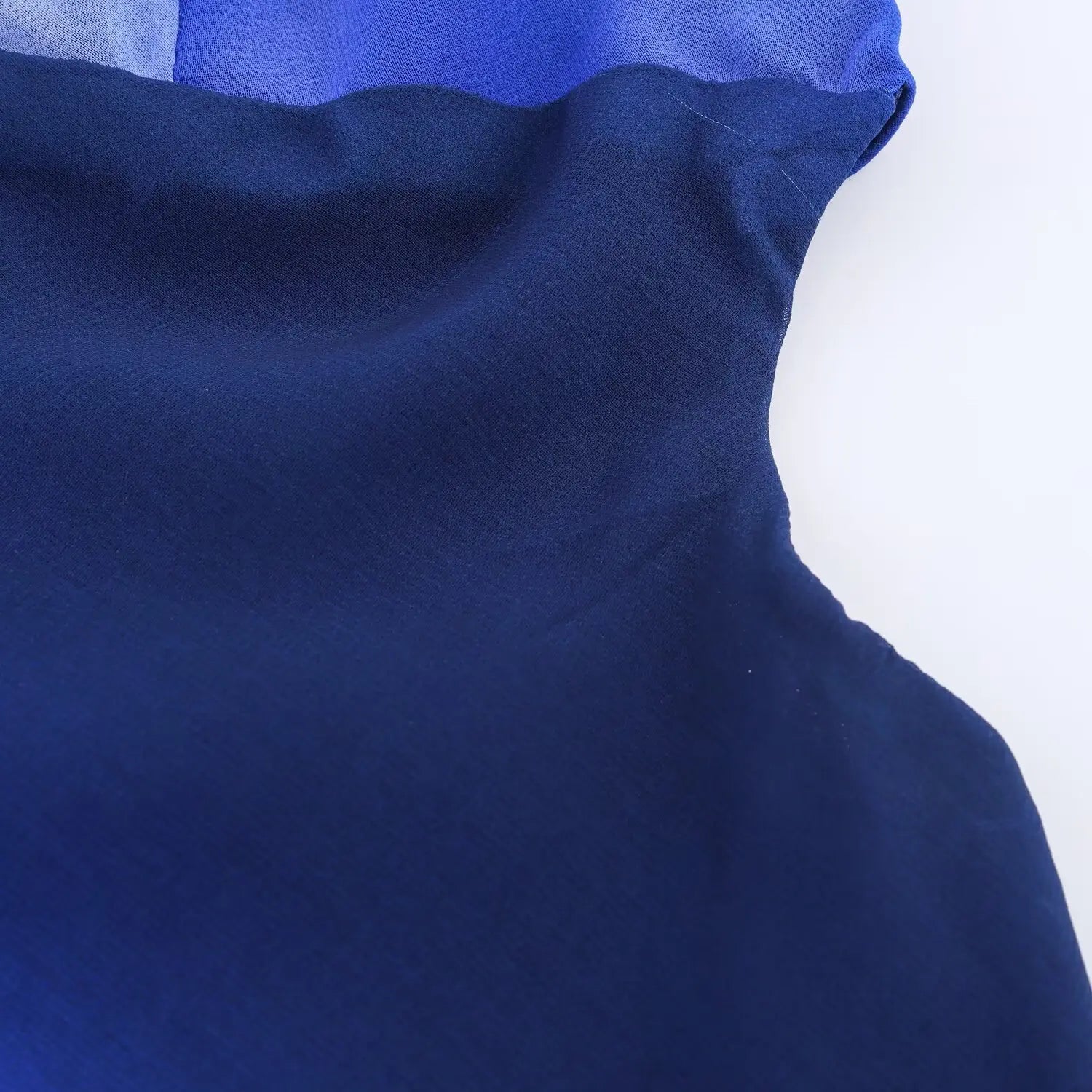 Close‑up of side cut‑out seam construction, blue gradient chiffon, tailored side cutout design detail