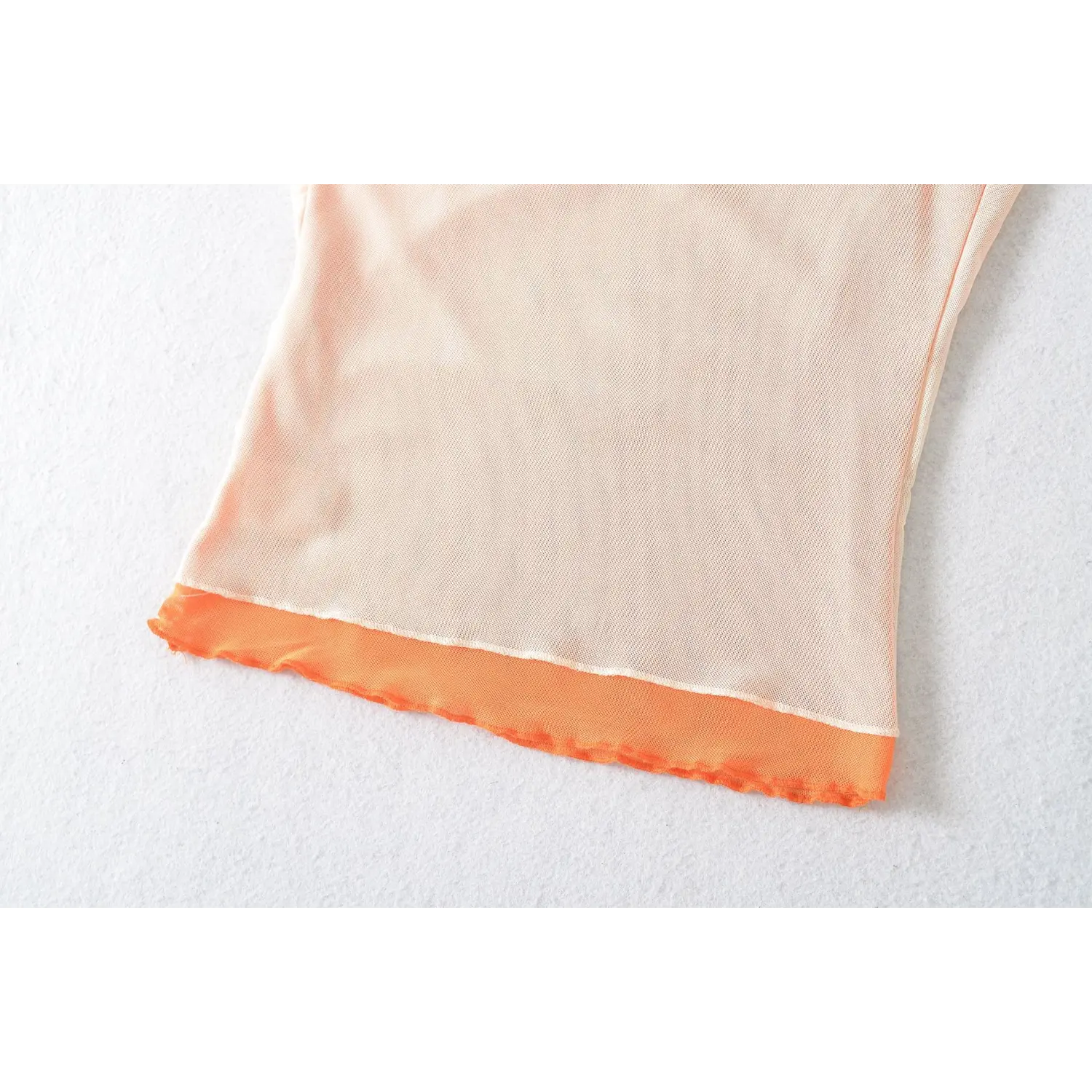 Mesh cami bottom hem wavy overlock stitch macro flat close-up, double mesh unified elastic overlock natural ruffle edge anti-curl sewing craft shot