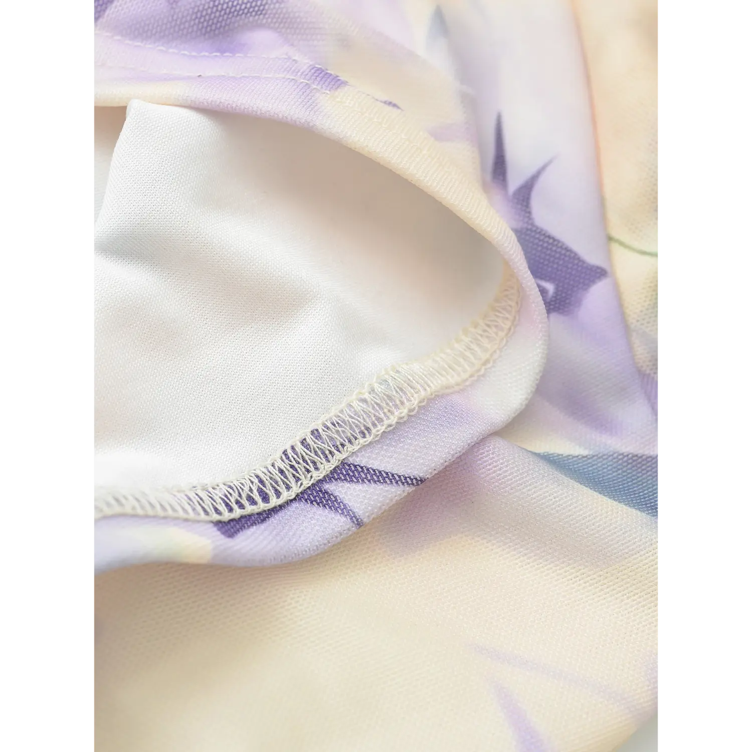 Mesh off-shoulder top inner solid lining macro flat close-up, opaque smooth white lining splice wavy overlock outer printed mesh double layer white background shot