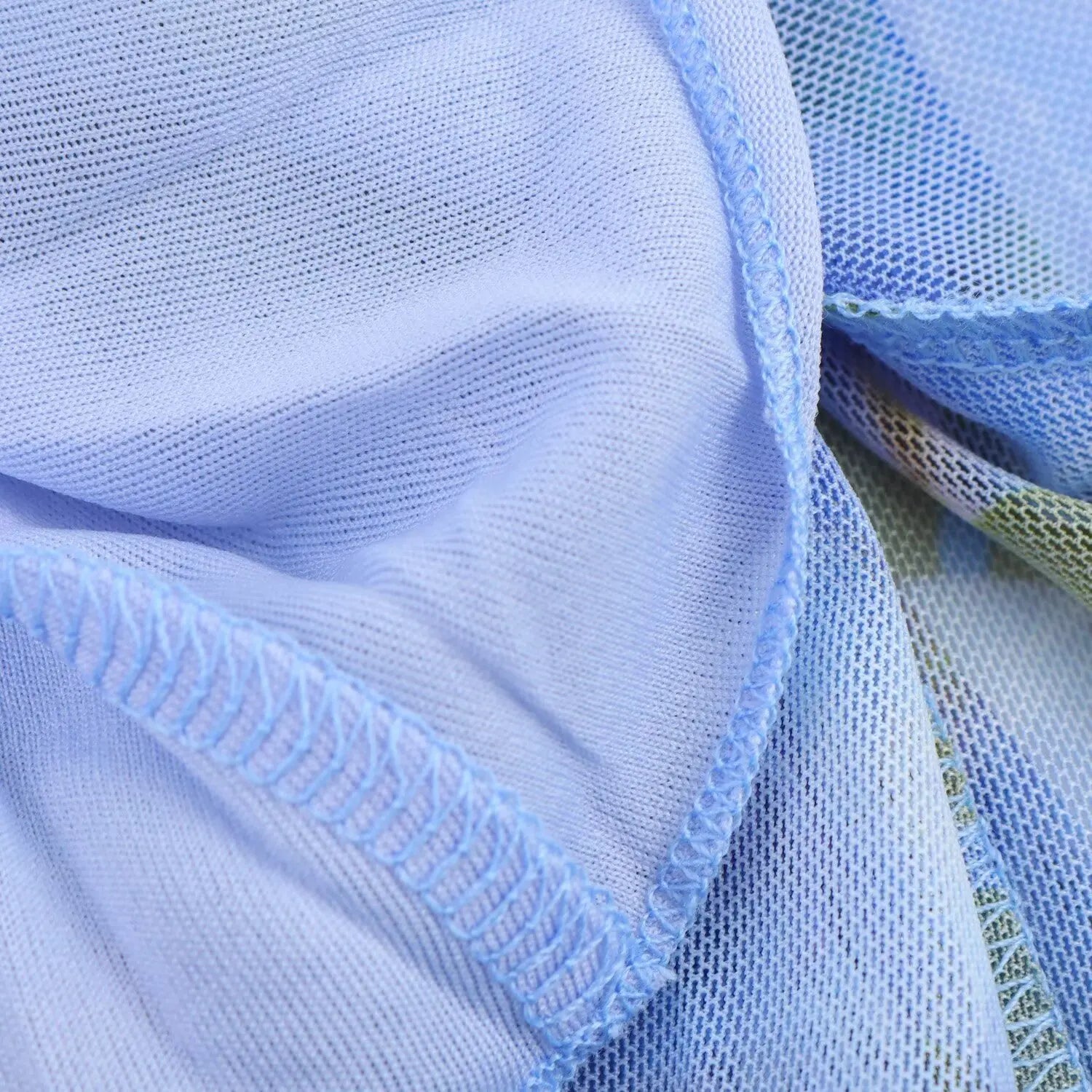 Close‑up of interior lining and fine finished stitching of blue floral mesh mini dress