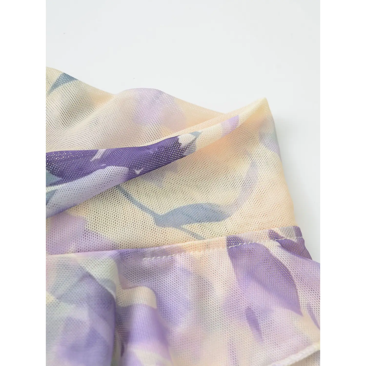 Mesh top double ruffle hem flat close-up, wavy elastic overlock double layered flounce gather stretch floral mesh cloth white background shot