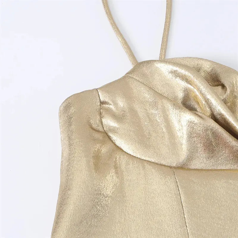 Macro shot draped cowl neck fabric, reflective metallic gold coated woven texture, soft ruched fold detail
