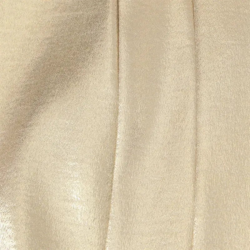 Front vertical corset panel stitching closeup, neat straight seam on reflective gold metallic fabric
