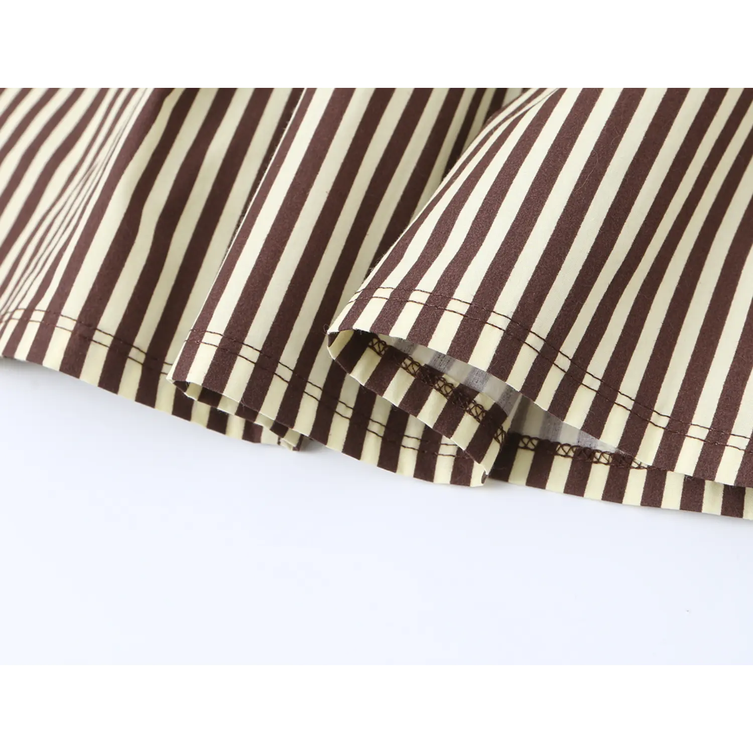 Fine stitching hem detail on brown white striped midi dress skirt