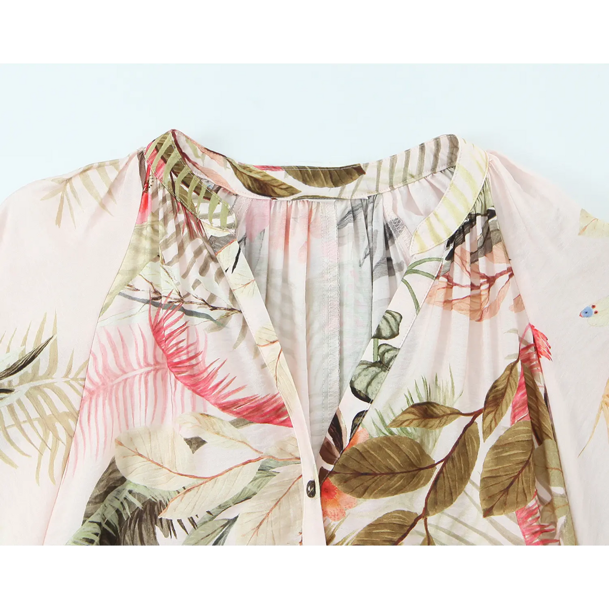 Close up of v neck gathered collar on pink tropical leaf print midi dress