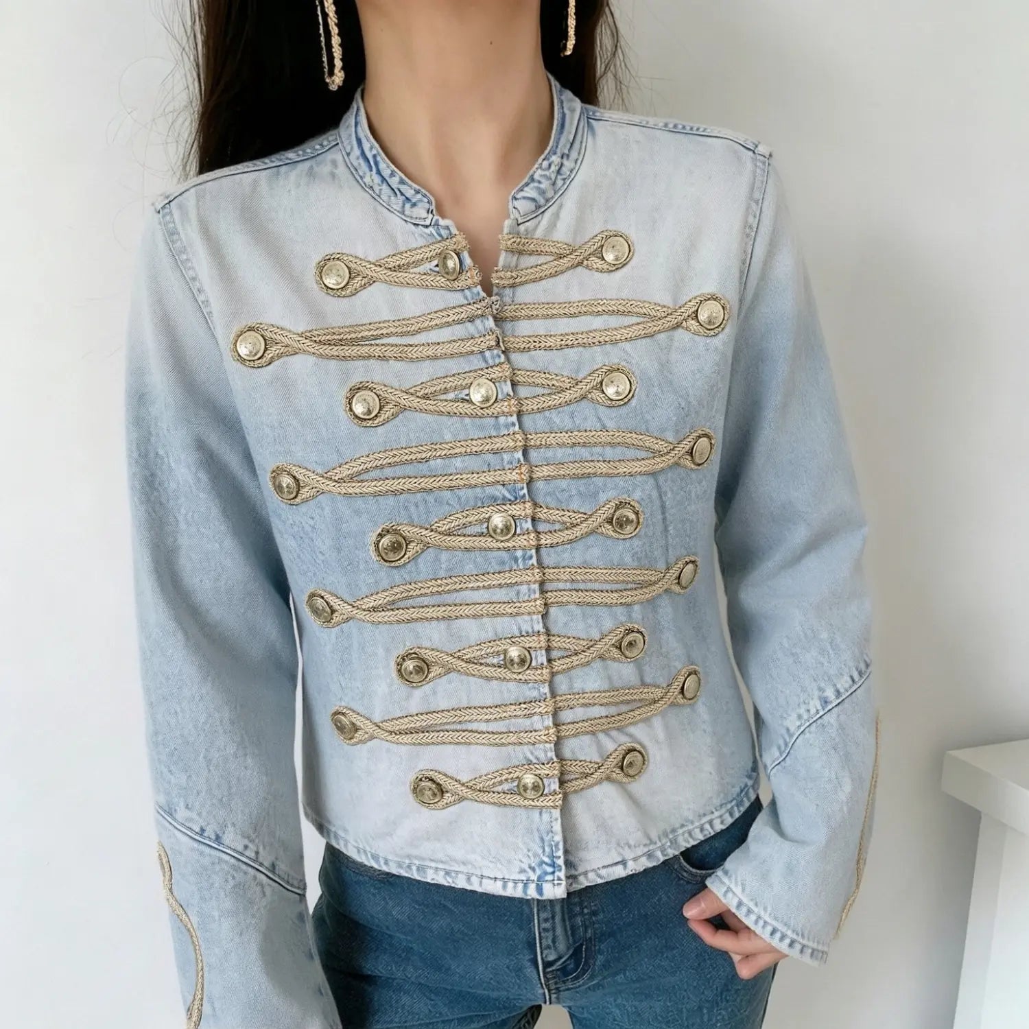 Model wearing light blue military denim jacket, front view decorative gold braiding and antique metal buttons outfit preview