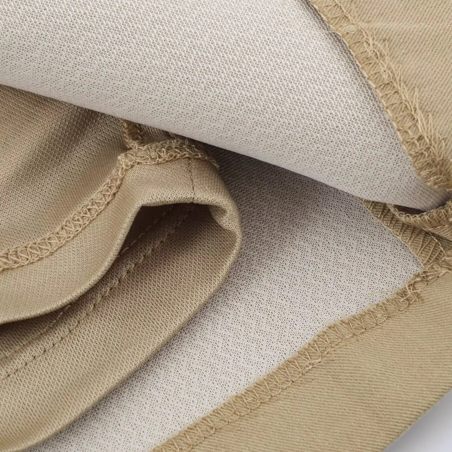 Close-up of soft full inner lining fabric and neat finished seams inside khaki camisole dress