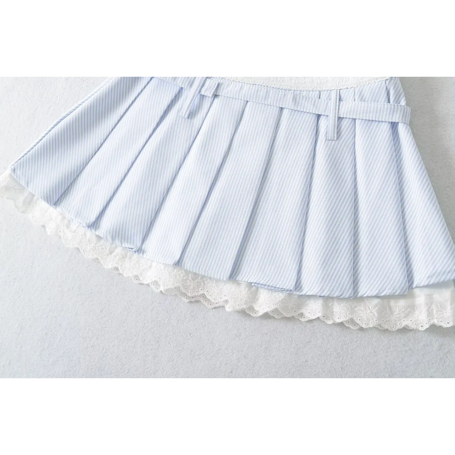 Mini skirt bottom double hollow embroidered scallop lace overlay macro close-up, layered lace hem hip covering fine serging anti-fray skirt detail shot