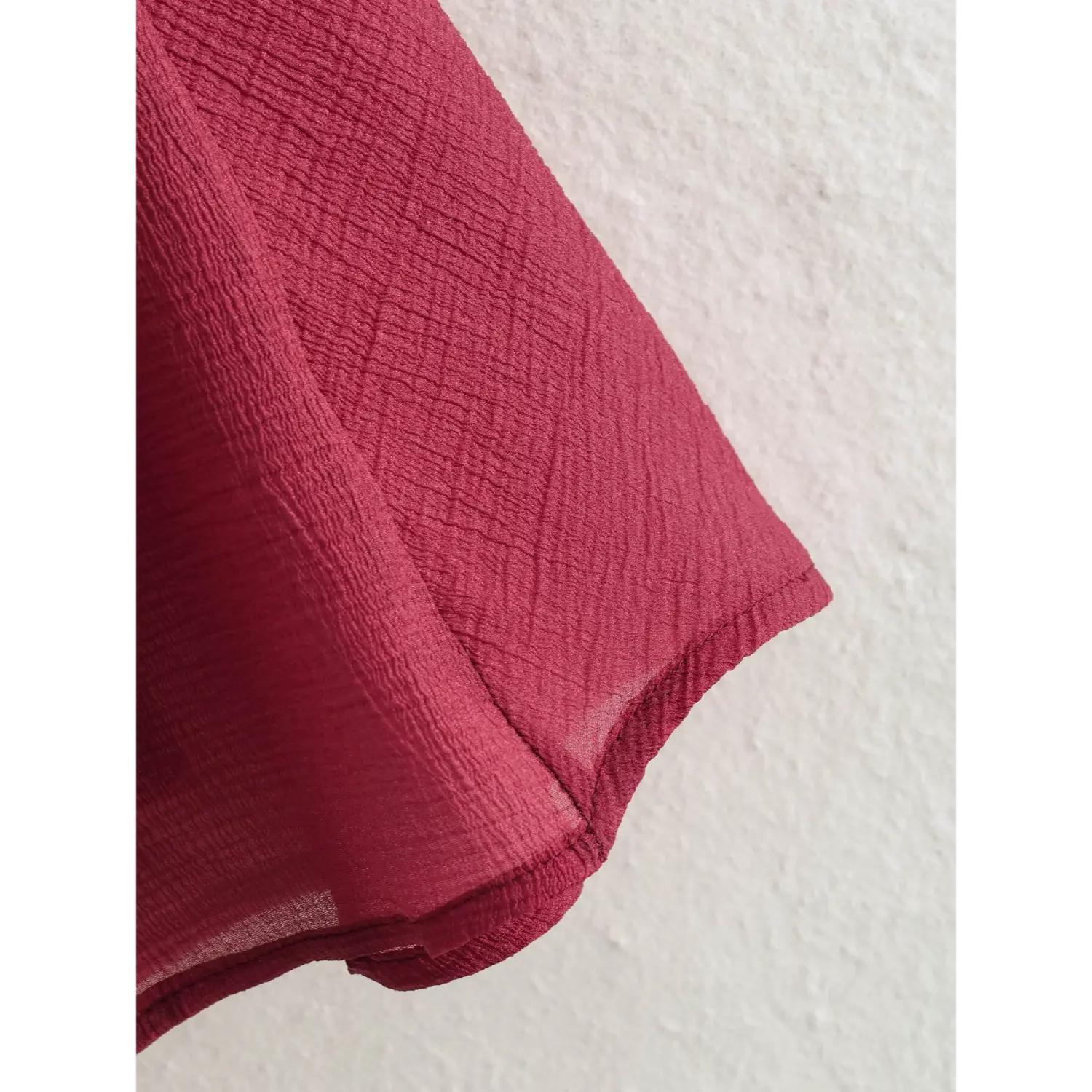 Skirt hem close-up double folded binding hem, lightweight semi-sheer crinkle outer layer, full opaque inner lining