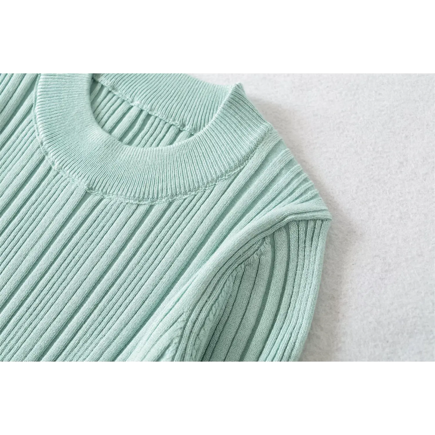 Crew neck closeup, mint ribbed knit mid sleeve top, ribbed collar stitching detail