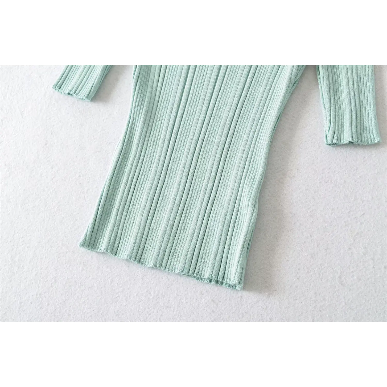 Hem & sleeve cuff detail shot, mint green crew neck rib knit top, neat finished edge