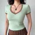 Close-up shot of the mint green fitted V-neck tee, showing the V-neckline and sleeve trim