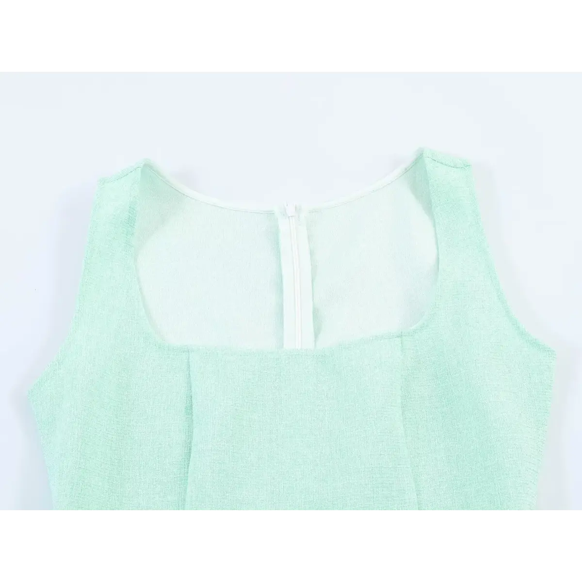 Back view of a mint green tweed sleeveless dress, highlighting the square neckline and center-back zipper closure.