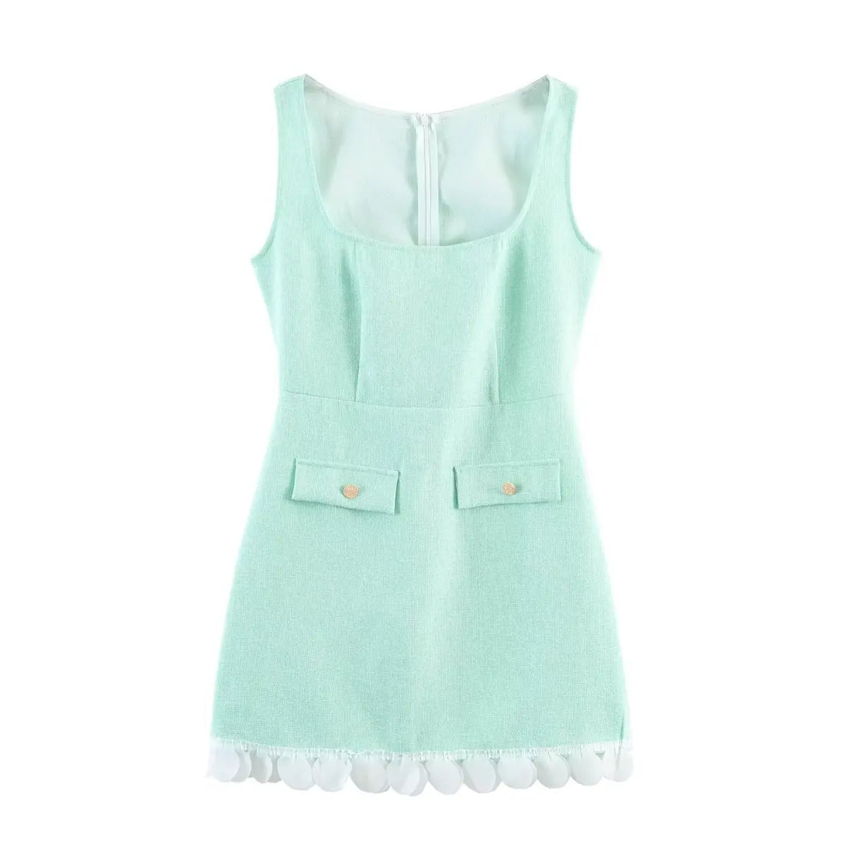 Full front view of a mint green tweed sleeveless mini dress, featuring faux pockets with gold buttons and decorative petal hem trim.
