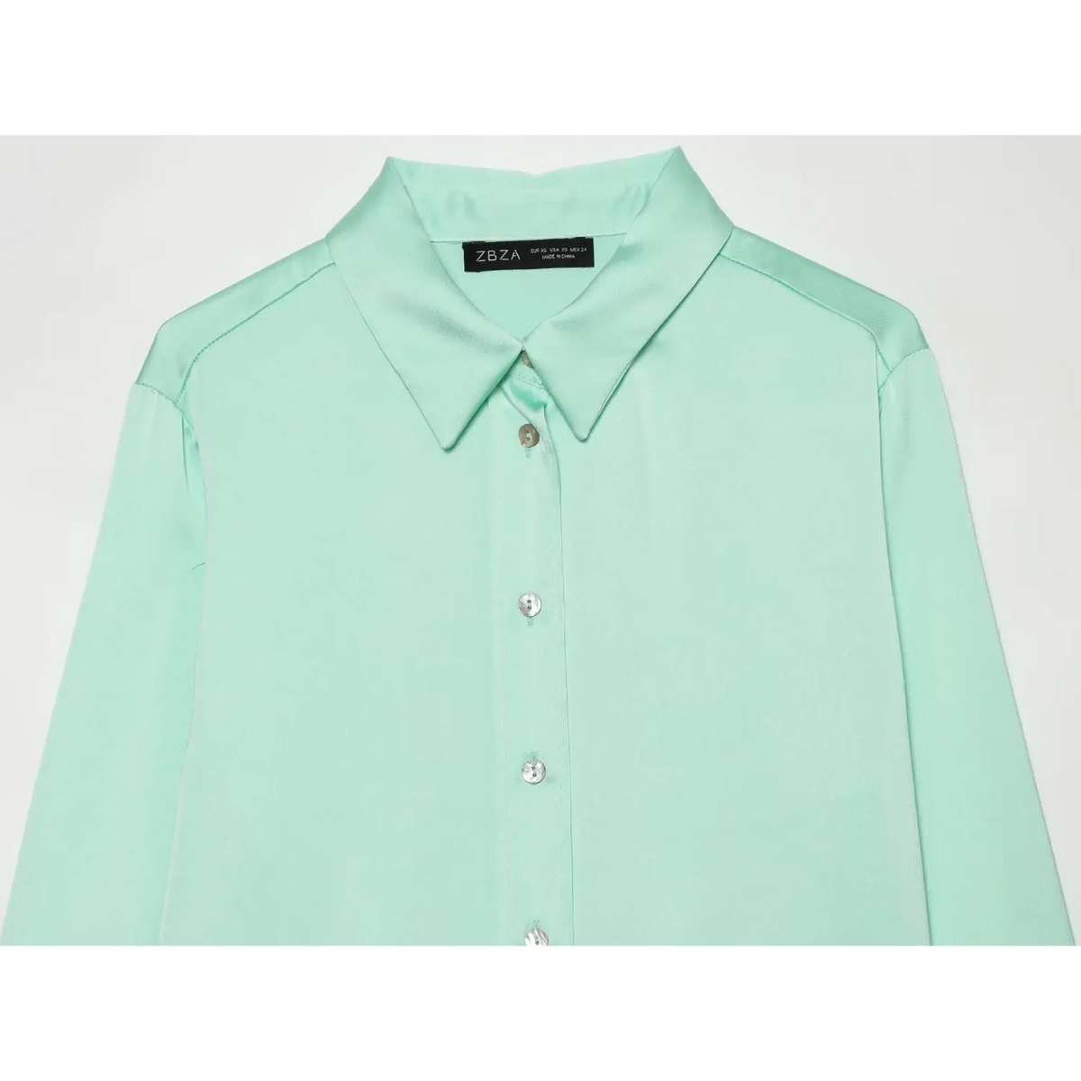 Close-up of pointed collar and button placket
