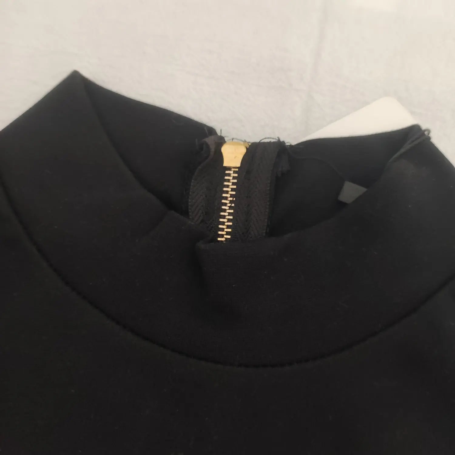  Close up mock neck collar with gold back zipper black long sleeve top
