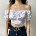 Front full shot lady in white off shoulder satin ruched drawstring crop top matched with jeans