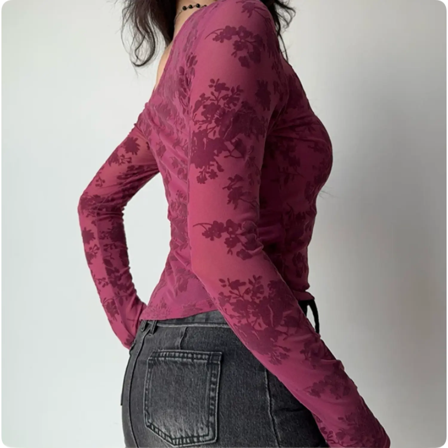 Model back side view mulberry pink floral print mesh long sleeve cropped top slim fit silhouette